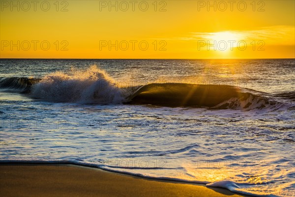 Sunrise with waves on the beach