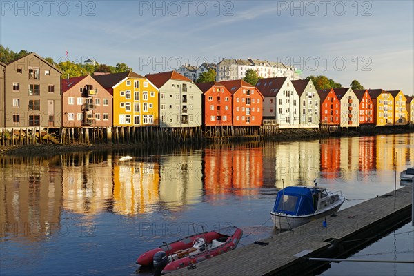 Wooden houses reflected in the river Nidarelva