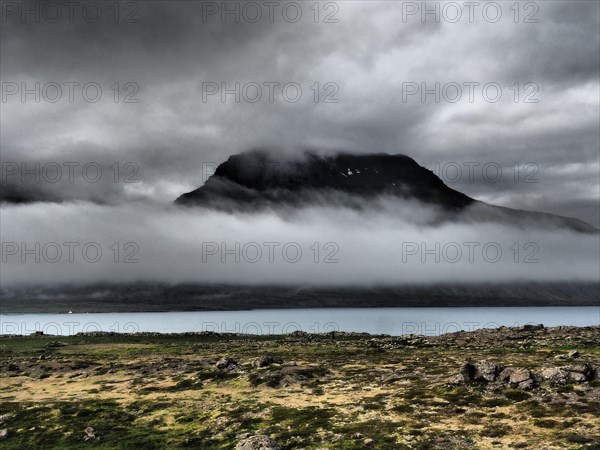 Fog drifts over mountainside