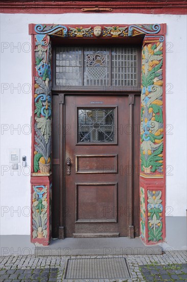 House door with wood carving and decoration of half-timbered house Town Hall