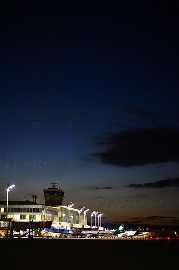 Apron East with satellite Terminal 2 at night with parked aircraft