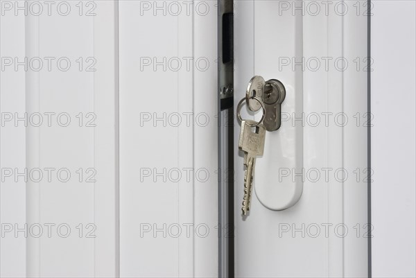 Keys unlocking a white door