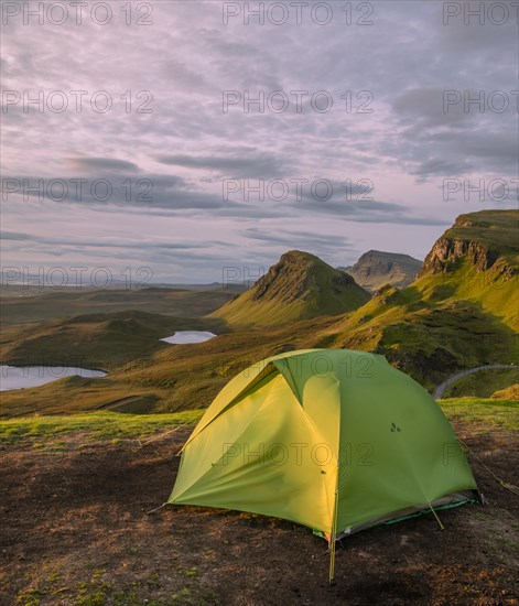 Tent overlooking rocky landscape Quiraing at sunrise