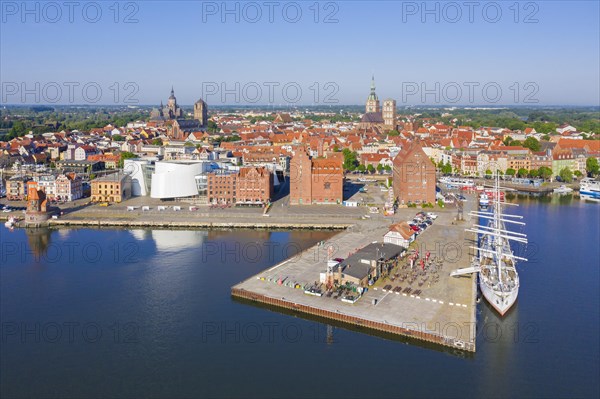 Aerial view over public aquarium Ozeaneum and three-mast barque Gorch Fock docked in harbour of the city Stralsund