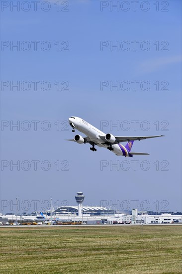 Take-off Thai Airways Boeing B777 Dreamliner with tower in the background