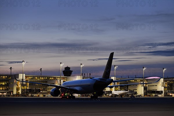 Lufthansa Airbus A350-900 New Livery being towed to position to Terminal 2 by tow truck at dusk