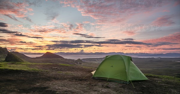 Tent overlooking rocky landscape Quiraing at sunrise