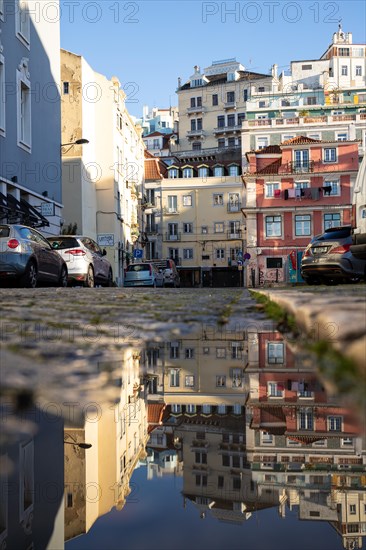 Old houses in narrow alleys and historic streets. Old house fronts in the morning and in the sunshine with reflection