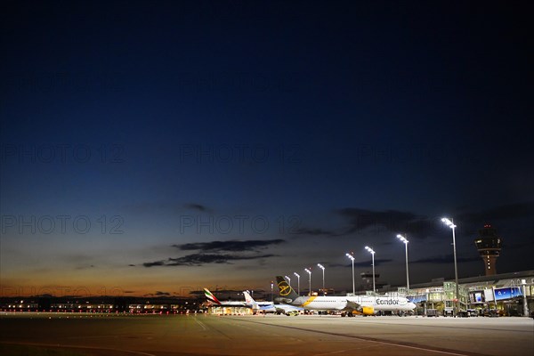 Apron West with Terminal 1 at night with tower and Condor and TUI fly