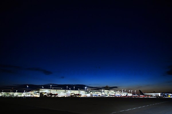 Apron East with satellite Terminal 2 at night with parked aircraft