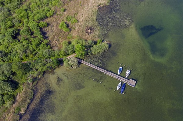 Aerial view over sailing boats moored at wooden jetty in lake Ratzeburger