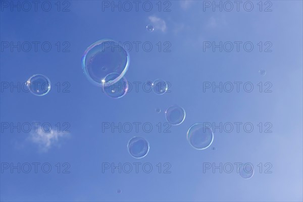 Soap bubbles against a blue sky