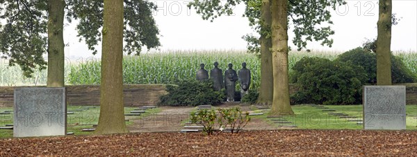 Sculpture group Trauernde Soldaten by Emil Krieger and German graves at the First World War One military cemetery Deutscher Soldatenfriedhof Langemark