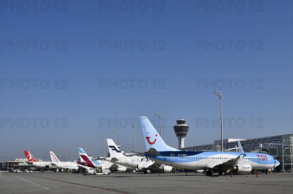 Aircraft on check-in position at Terminal 1 with tower