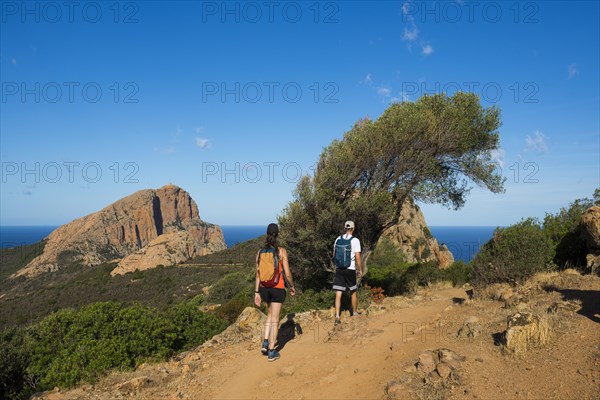 Red granite rocks and hikers