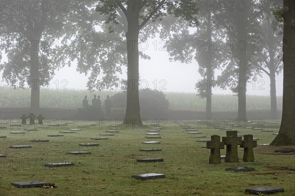 Sculpture group Trauernde Soldaten by Emil Krieger and German graves at the First World War One military cemetery Deutscher Soldatenfriedhof Langemark