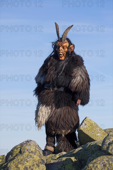 Scary wooden devil figure on the summit of Mount Lusen in autumn