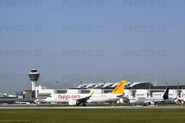 Pegasus Boeing B737 waiting for take-off clearance on runway south with tower