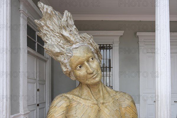 Imaginary deity â€œTalanaâ€ statue made of recycled cardboard in front the municipal library