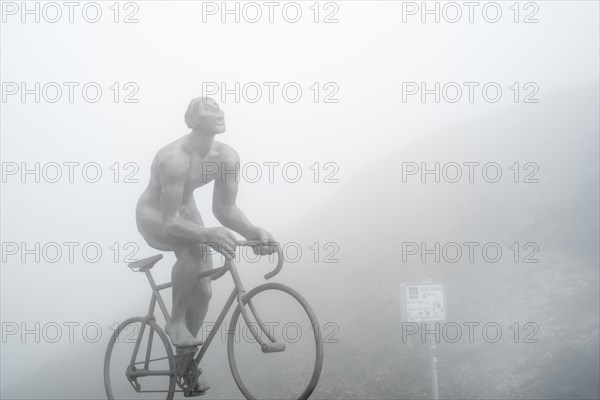 Statue for Tour de France cyclist Octave Lapize at the Col du Tourmalet in thick mist in the Pyrenees
