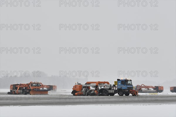 Road sweepers and snow ploughs clear snow on the taxiways and Runway North