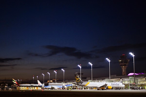 Terminal 1 at night with tower and Condor and TUI fly