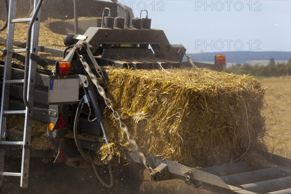 Tractor with a straw baler