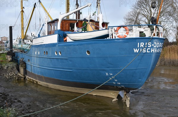 Ship stuck in the mud at low tide in Wischhafen