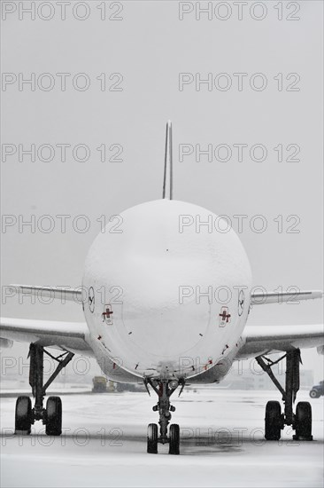 Snow-covered Lufthansa aircraft in winter with snow on apron