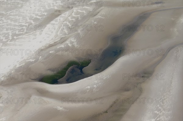 Aerial view showing walkers on tidal mud flat at the Schleswig-Holstein Wadden Sea National Park