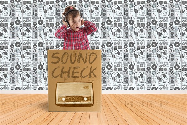 Child with headphones does the sound check