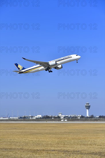 Singapore Airlines Airbus A350-900 taking off on runway south with tower