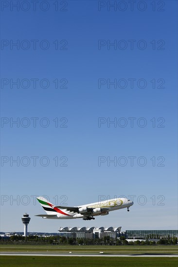 Take-off Emirates Airlines special livery 50th anniversary of the UAE United Arab Emirates Airbus A380-800 with tower in the background