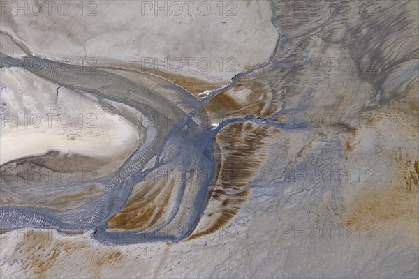 Aerial view of stream running through tidal mudflat at the Schleswig-Holstein Wadden Sea National Park