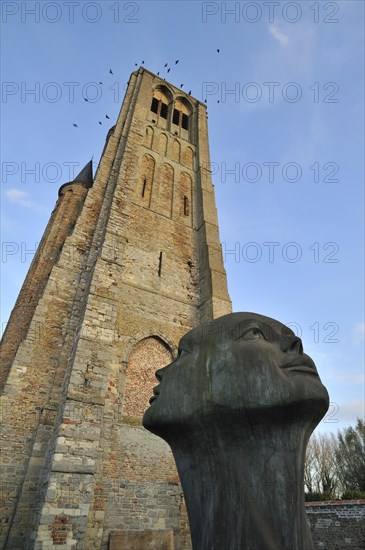 The statue Blik van Licht in front of the Church of Our Lady in the town Damme