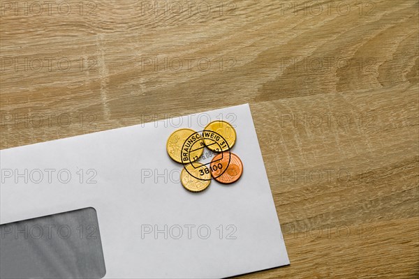 Postage in cent coins on an envelope