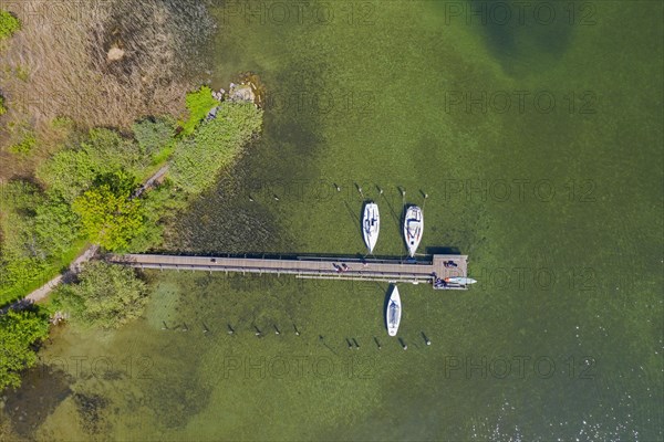 Aerial view over sailing boats moored at wooden jetty in lake Ratzeburger