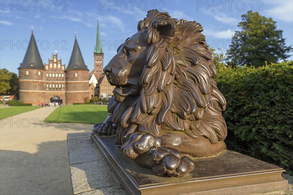 Lion statue in front of the Holstentor Holstein Gate in the Hanseatic town Luebeck