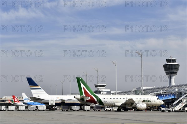 Aircraft on check-in position at Terminal 1 with tower