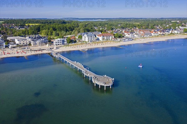 Aerial view over wooden pleasure pier and hotels at seaside resort Niendorf along the Baltic Sea