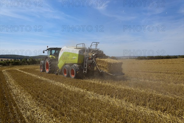 Tractor with a straw baler