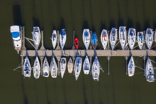 Aerial view over berthing jetty with sailing boats at marina in harbour of the city Stralsund along the Strelasund