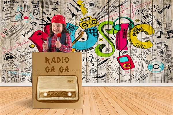 Child as disc jockey stands in a box with a microphone