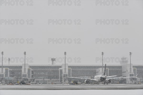 Snow clearing machines and snow removal tractors clearing snow on the east apron