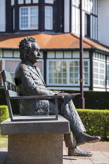 Albert Einstein statue sitting on a park bench at the seaside resort De Haan