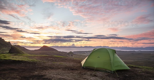 Tent overlooking rocky landscape Quiraing at sunrise