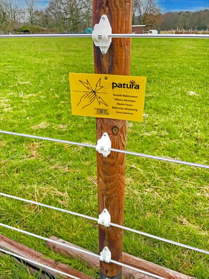 Warning sign on electric fence in wolf area Kirchhellen