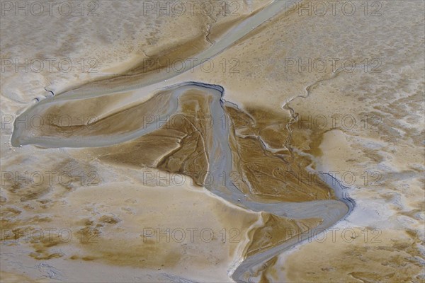 Aerial view of stream running through tidal mudflat at the Schleswig-Holstein Wadden Sea National Park