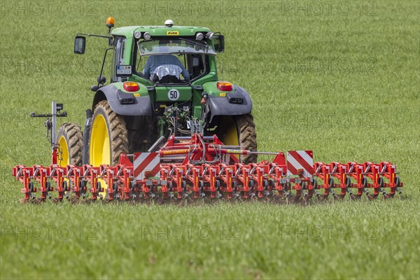 Farmer with tractor working in the field