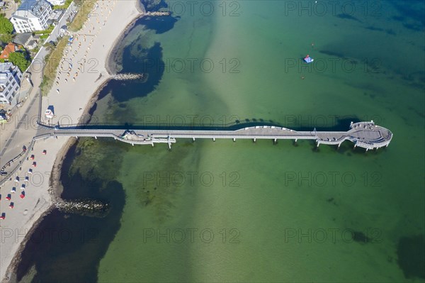 Aerial view over wooden pleasure pier and hotels at seaside resort Niendorf along the Baltic Sea